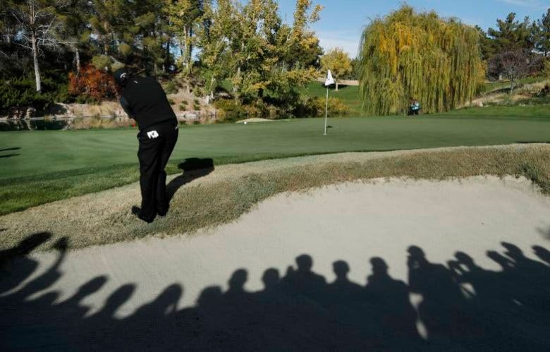 Phil Mickelson hits onto the fourth green during a golf match against Tiger Woods at Shadow Creek golf course, Friday, Nov. 23, 2018, in Las Vegas. (AP Photo/John Locher)