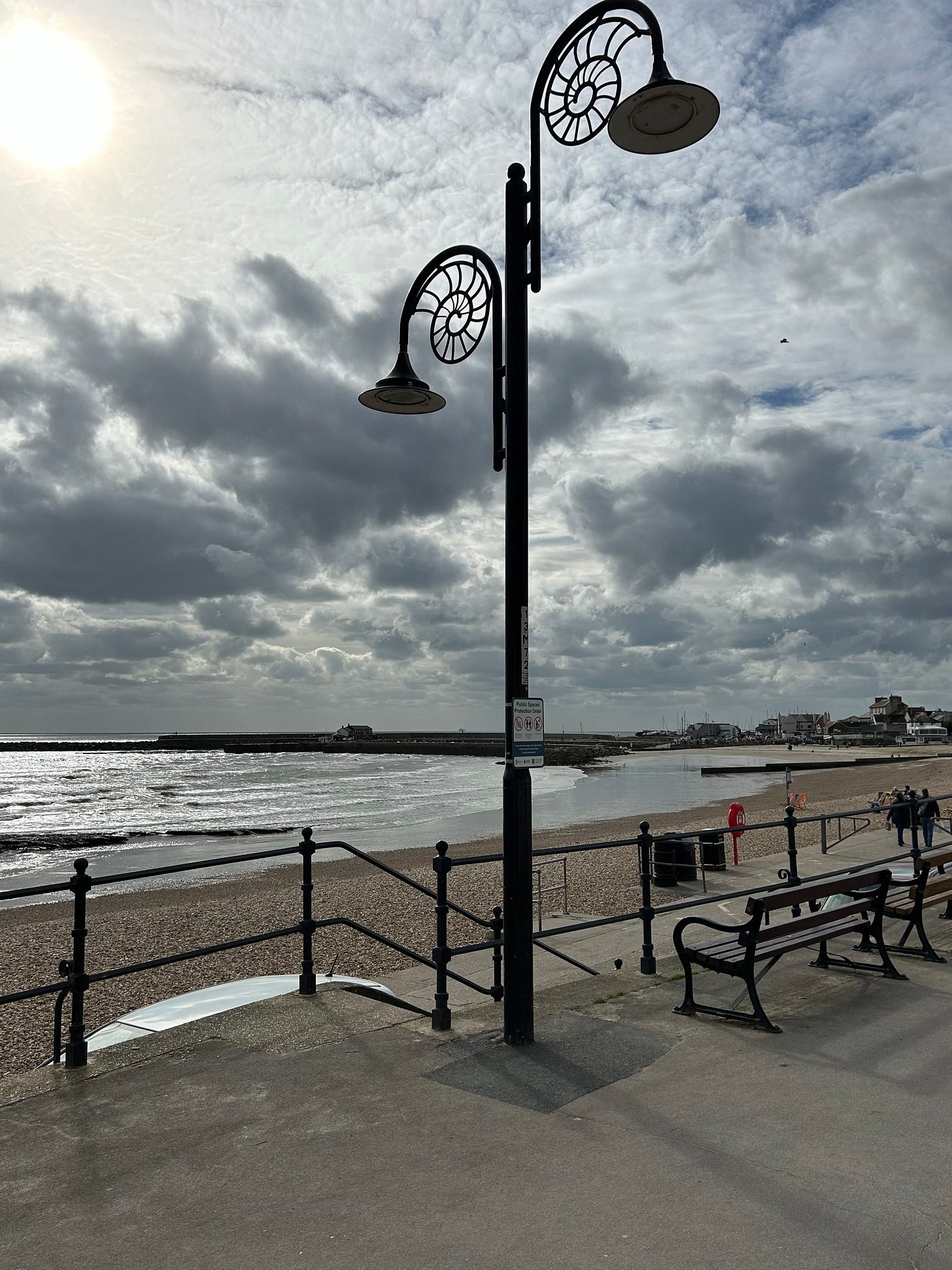 A double light bearing lamppost in Lyme Regis with ammonite scrolls. Image: Roland's Travels