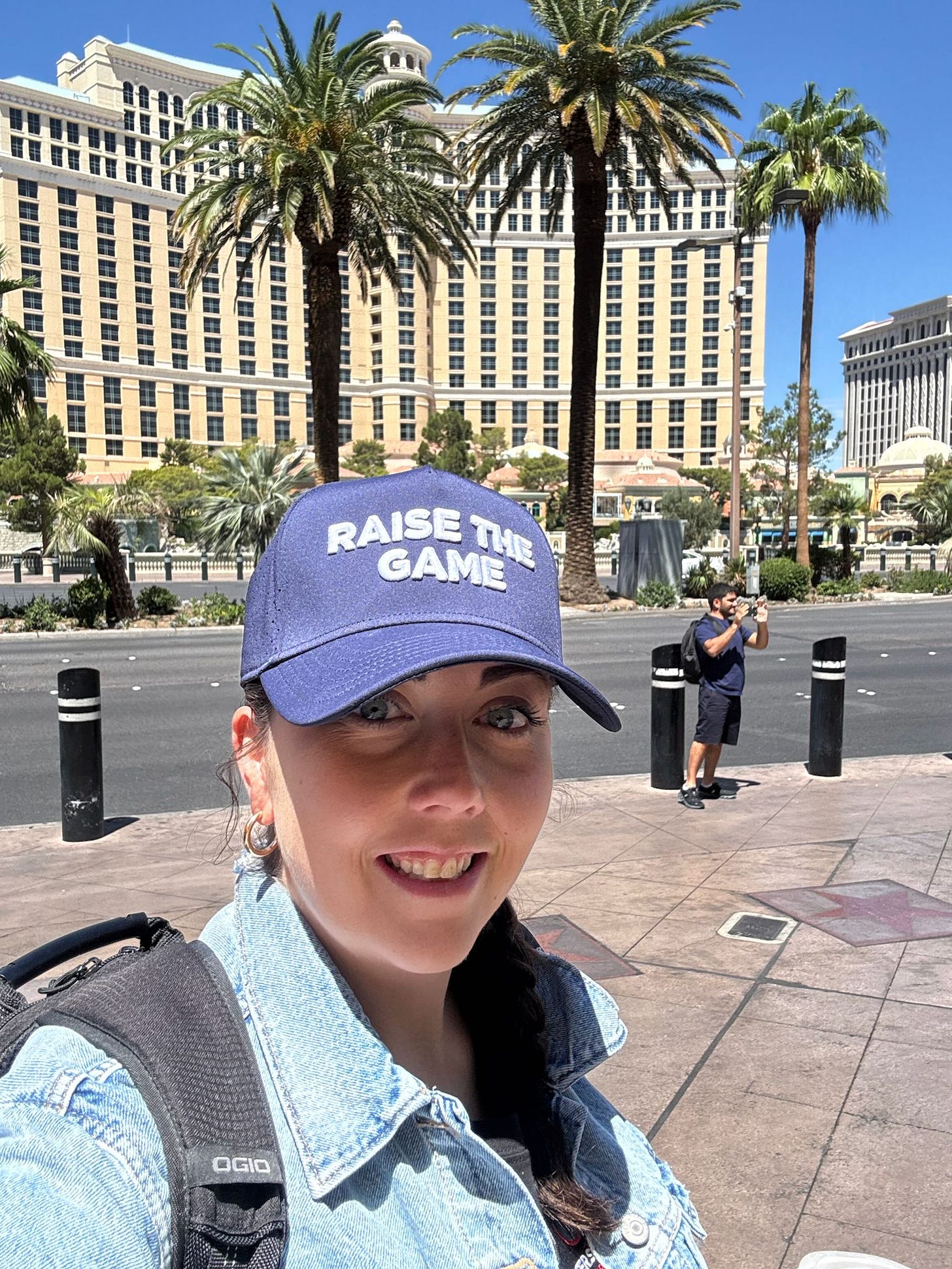 Katlyn Slone smiling outdoors in front of the Bellagio in Las Vegas, wearing a blue RAISE THE GAME hat, denim jacket, and backpack. She’s lit by full sun, heading into Day 4 of the WSOP Main Event. Katlyn Slone smiling outdoors in front of the Bellagio in Las Vegas, wearing a blue RAISE THE GAME hat, denim jacket, and backpack. She’s lit by full sun, heading into Day 4 of the WSOP Main Event.