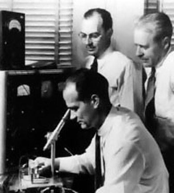 William Shockley (seated), John Bardeen(standing left), and Walter Brattain.  William Shockley (seated), John Bardeen(standing left), and Walter Brattain.