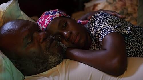 A couple laying together on the bed, enjoying each other's company.