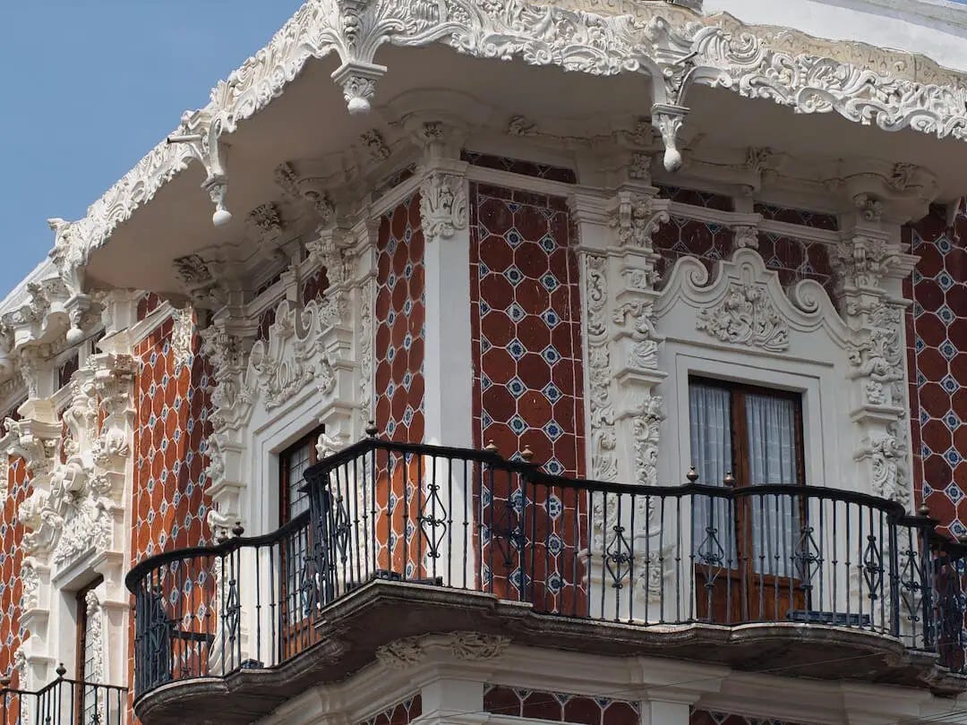 A building with red tiles and white stuccato decoration