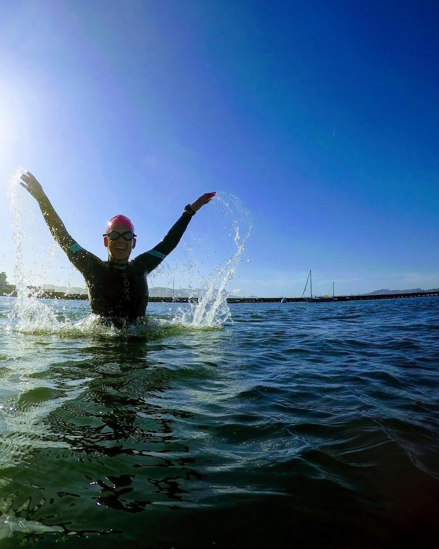 Caroline Davis in open water wearing a wetsuit and a swim cap Caroline Davis in open water wearing a wetsuit and a swim cap
