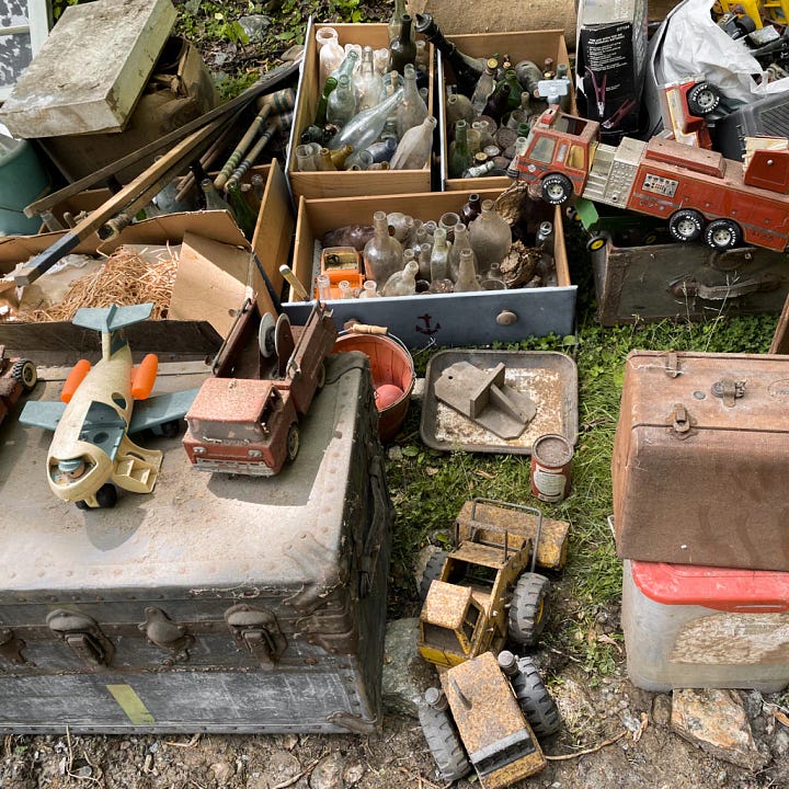 Treasures found in the old barn. Vintage toys, an old trunk, wooden chairs, an old telephone operator.