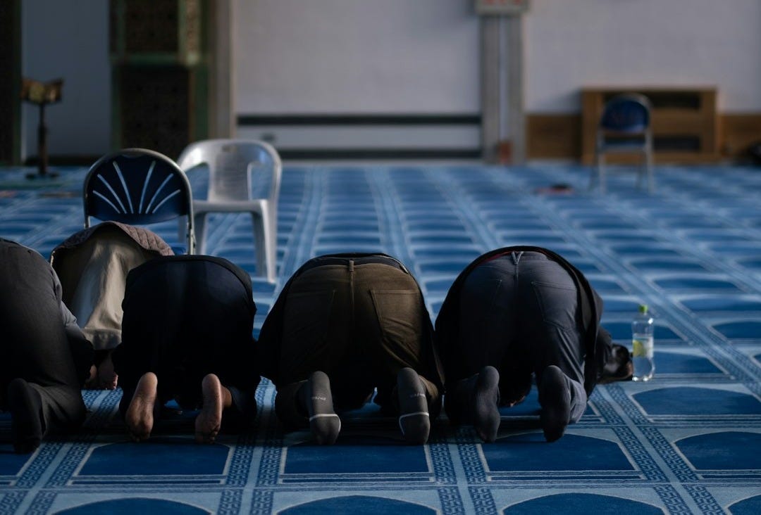 a group of people laying on top of a blue floor
