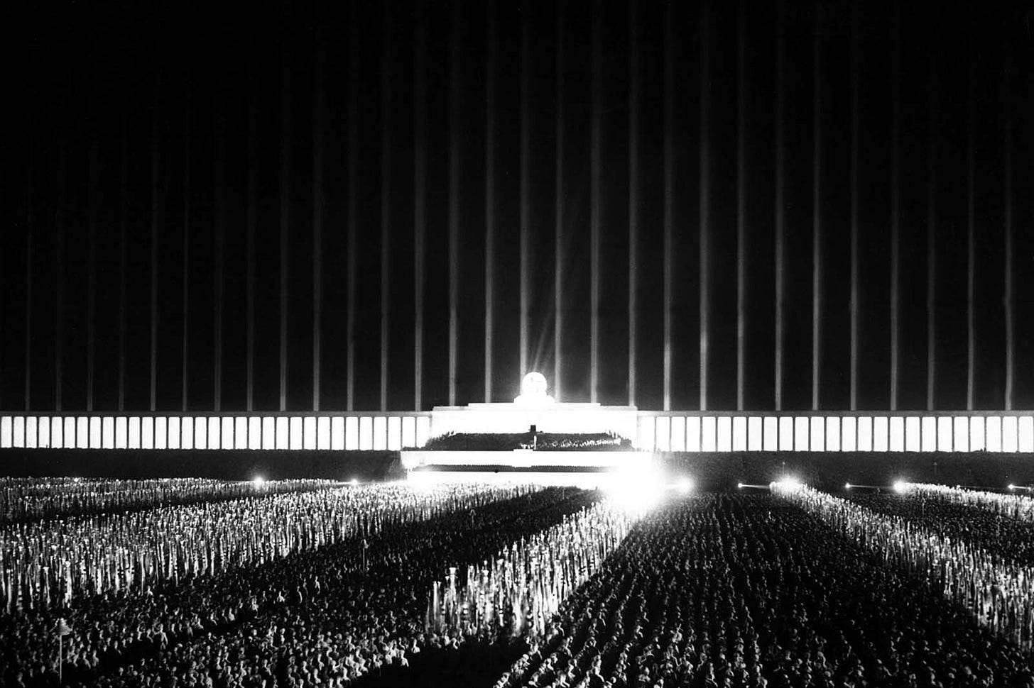 A captivating view of the Nazi rally bathed in the 'Cathedral of Light,' 1937. A captivating view of the Nazi rally bathed in the 'Cathedral of Light,' 1937.