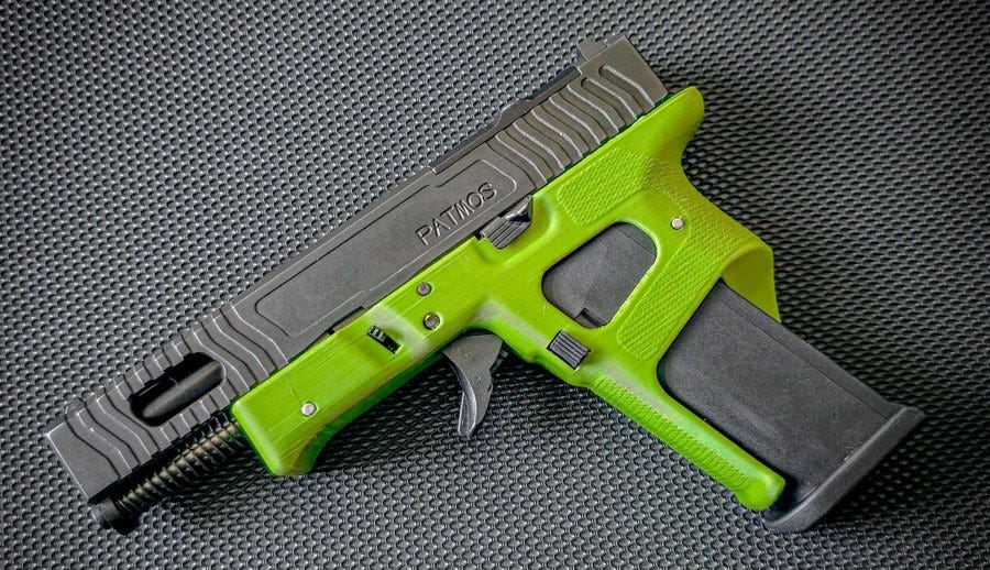 A Glock 19 firearm with a bright green MSRG-19 frame and a black slide. The slide has the text "PATIOS" engraved on it. The firearm is positioned on a textured gray surface.