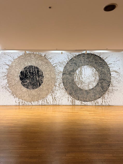 A grid of nine images depicting artworks by various artists, including Bruce Nauman, Jannis Kounellis, John Chamberlain, Yves Klein, Louise Nevelsen, Jenny Holzer, and Kan Yasuda.