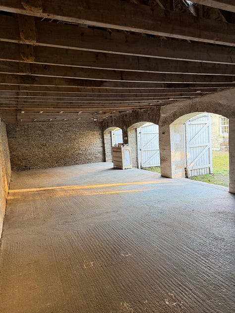 Three photos of an old barn with arched doors and light streaming in.