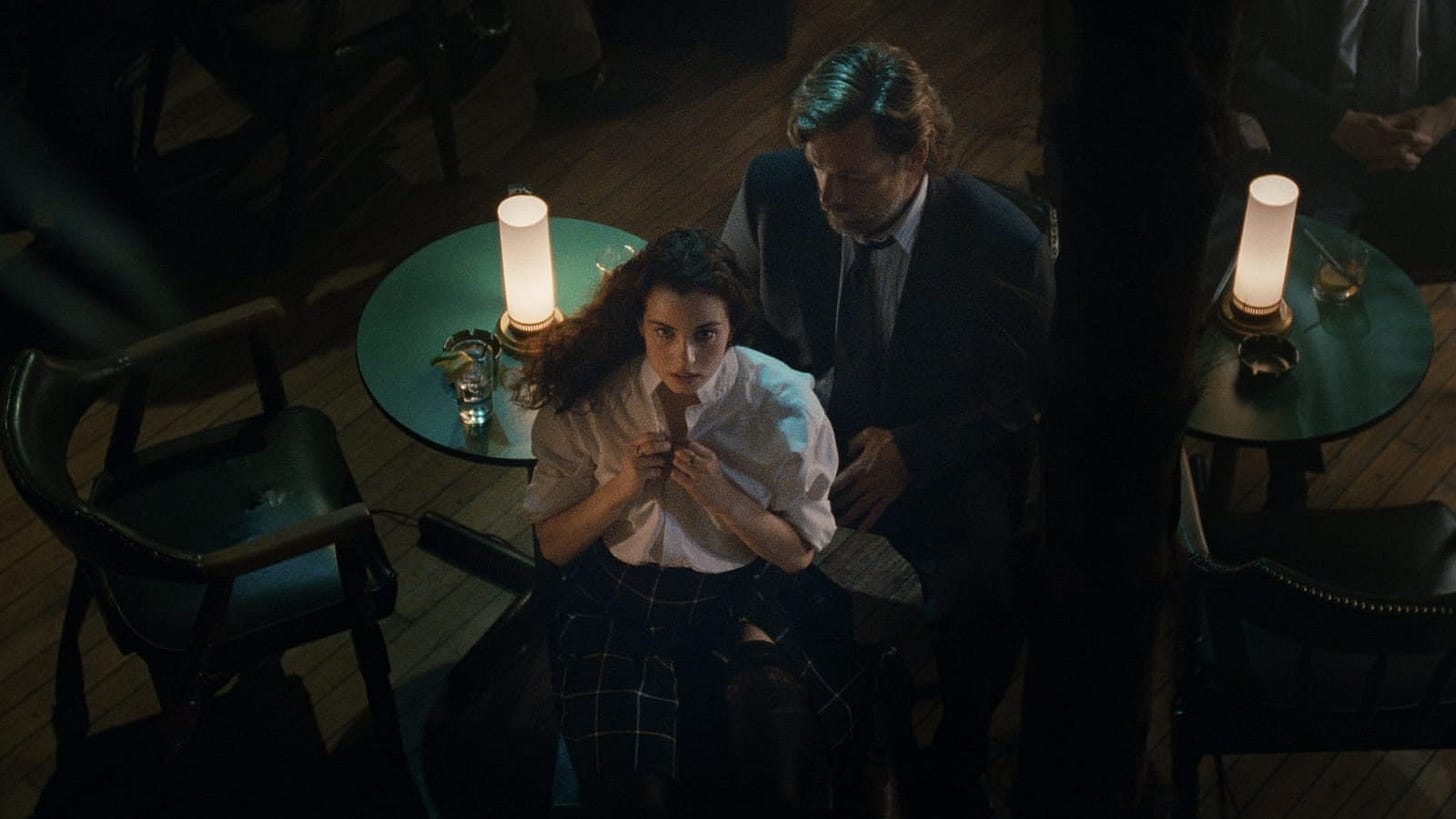 Exotica | Still features Mia Kirshner as Christina performing a striptease routine for Bruce Greenwood's Francis.