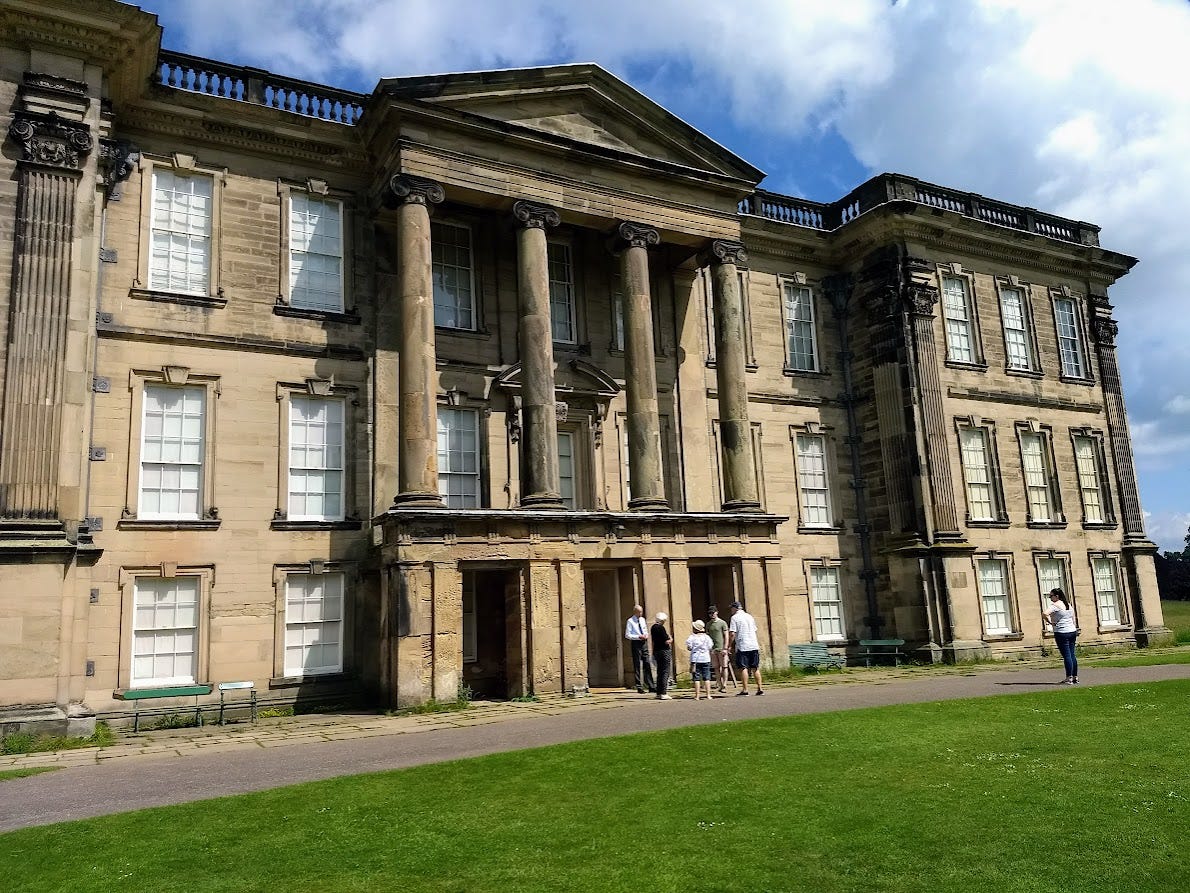 Large stone mansion with classical columns