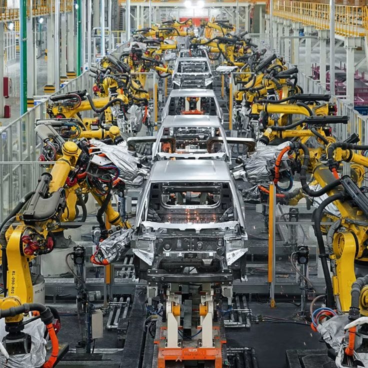 This may contain: an assembly line with robots working on cars