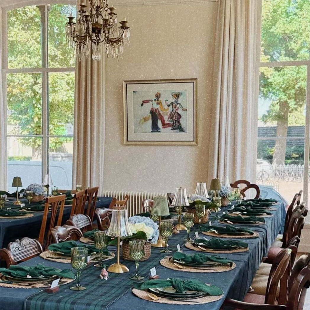 A table set up for a party with small lamps and plaid linens