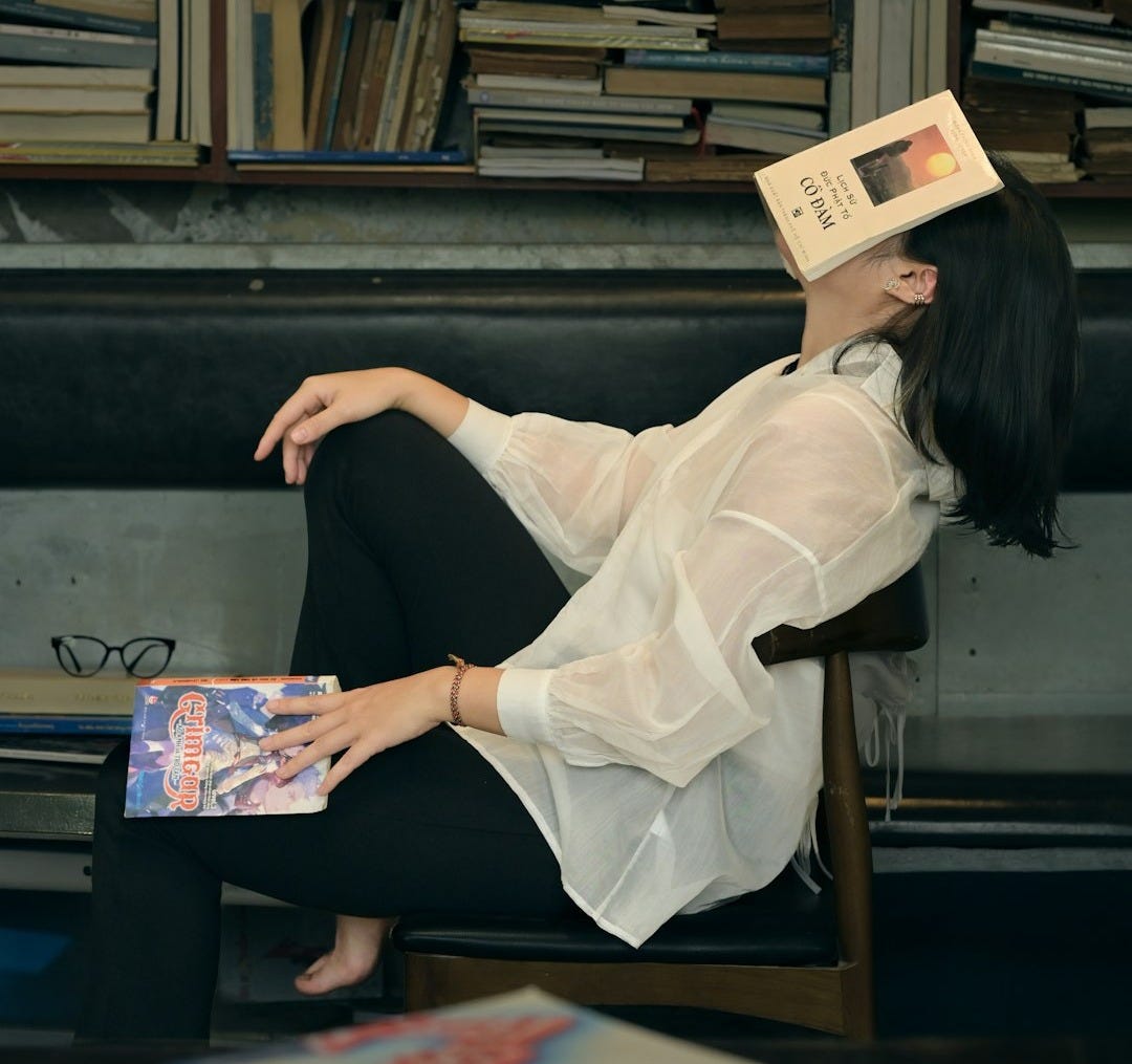 Woman sleeping with book on her face
