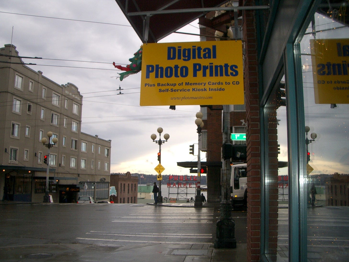Sign hanging outside a retail location overlooking the Pike Place Market in Seattle Sign hanging outside a retail location overlooking the Pike Place Market in Seattle