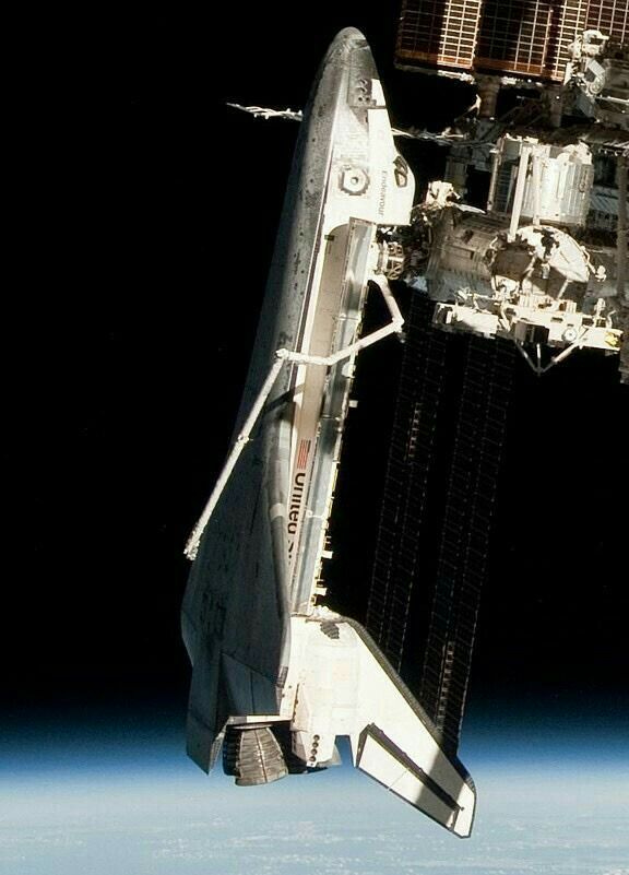 This may contain: the space shuttle is docked to the international space station in this photo taken by nasa astronauts This may contain: the space shuttle is docked to the international space station in this photo taken by nasa astronauts