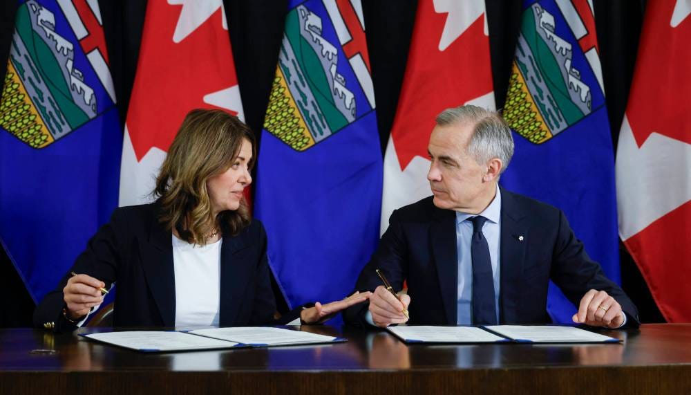 The Canadian Press
                                Prime Minister Mark Carney, right, signs an MOU with Alberta Premier Danielle Smith in Calgary, Alta. on Thursday.