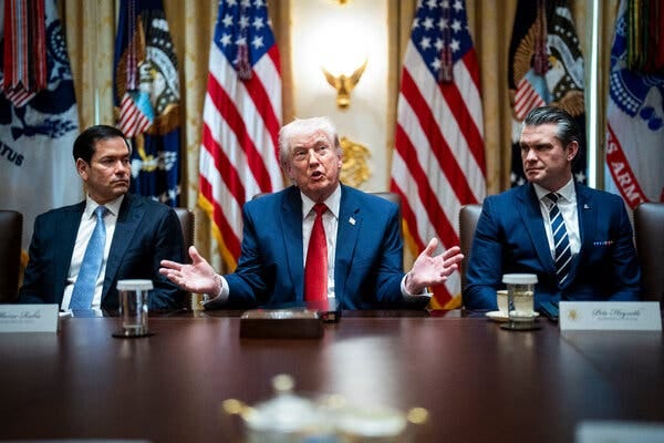 President Trump speaking with his hands raised sitting next to Secretary of State Marco Rubio and Defense Secretary Pete Hegseth. President Trump speaking with his hands raised sitting next to Secretary of State Marco Rubio and Defense Secretary Pete Hegseth.