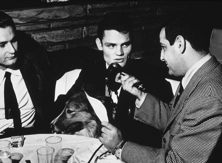American jazz trumpeter and singer Chet Baker is interviewed whilst sitting with a collie, 13th December 1954. Photo by Bob Parent/Archive Photos/Getty Images