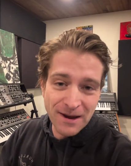 Man with music mixing equipment behind him