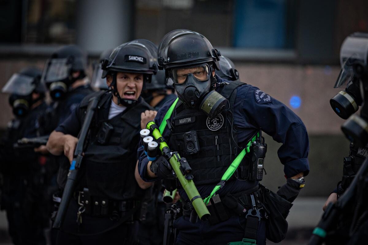 LAPD clear the street outside the Metropolitan Detention Center.
