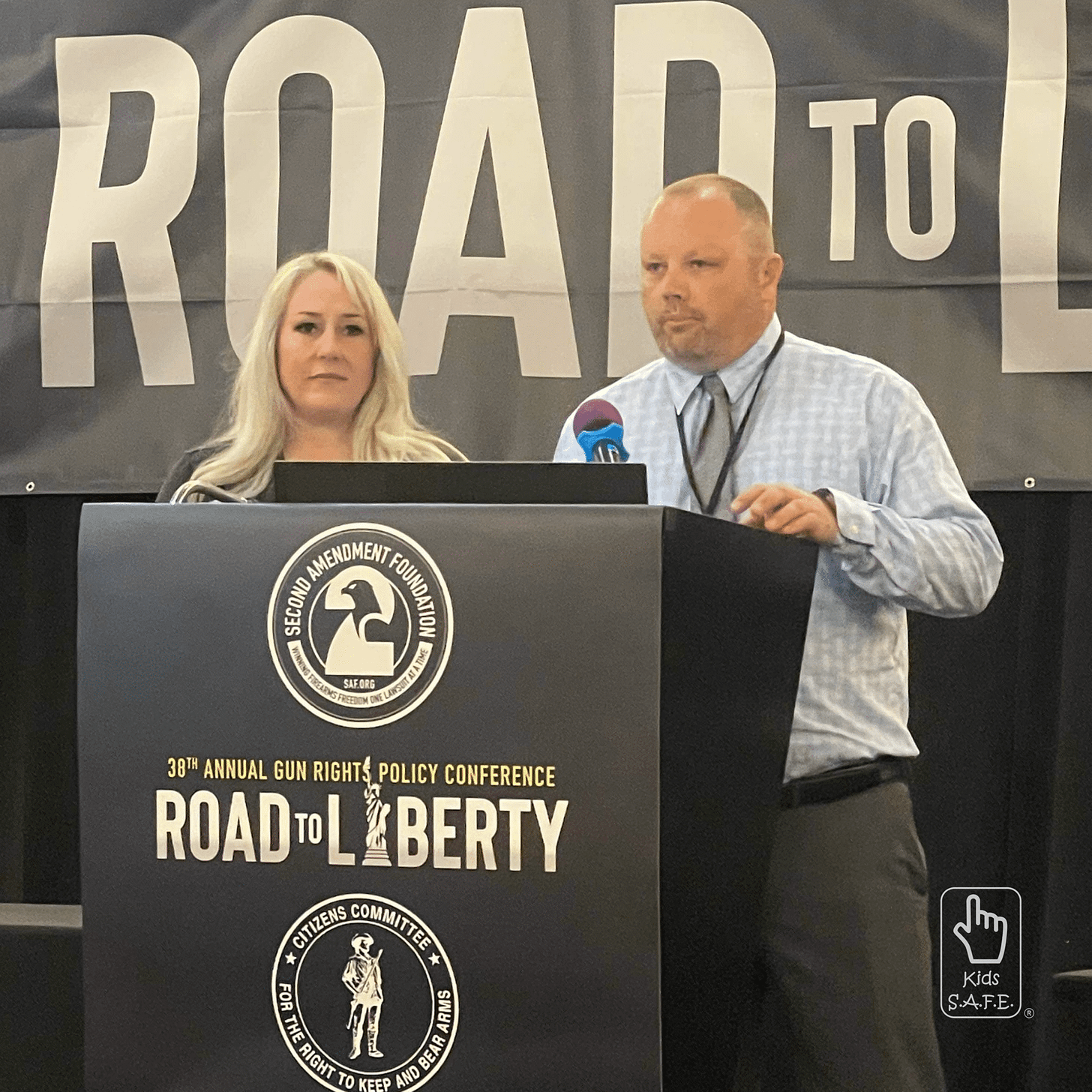 Two speakers at gun rights policy conference podium.