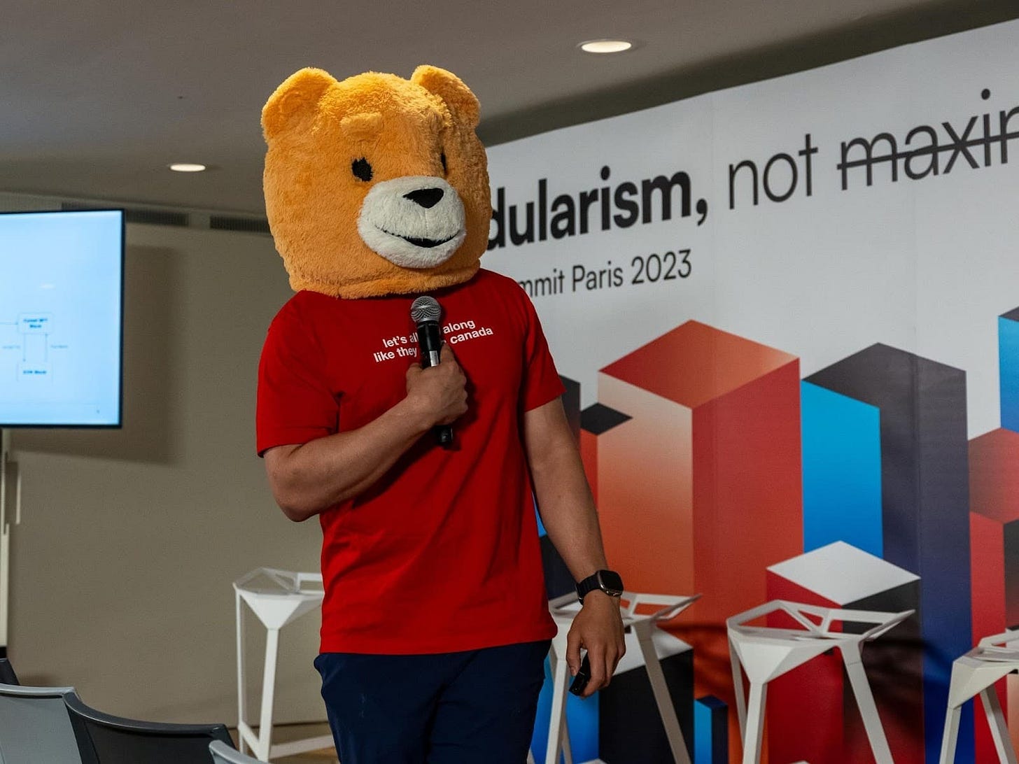 Berachain's co founder at a public event with the Bera mascot on.