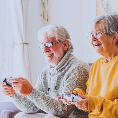 male and female seniors playing nintendo switch for older adults