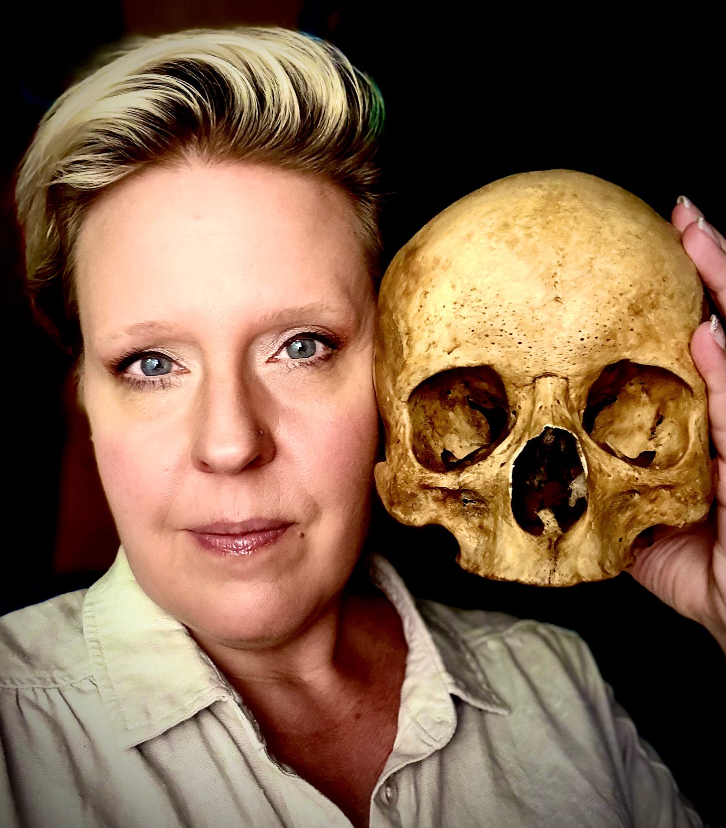 Blond woman with a human skull