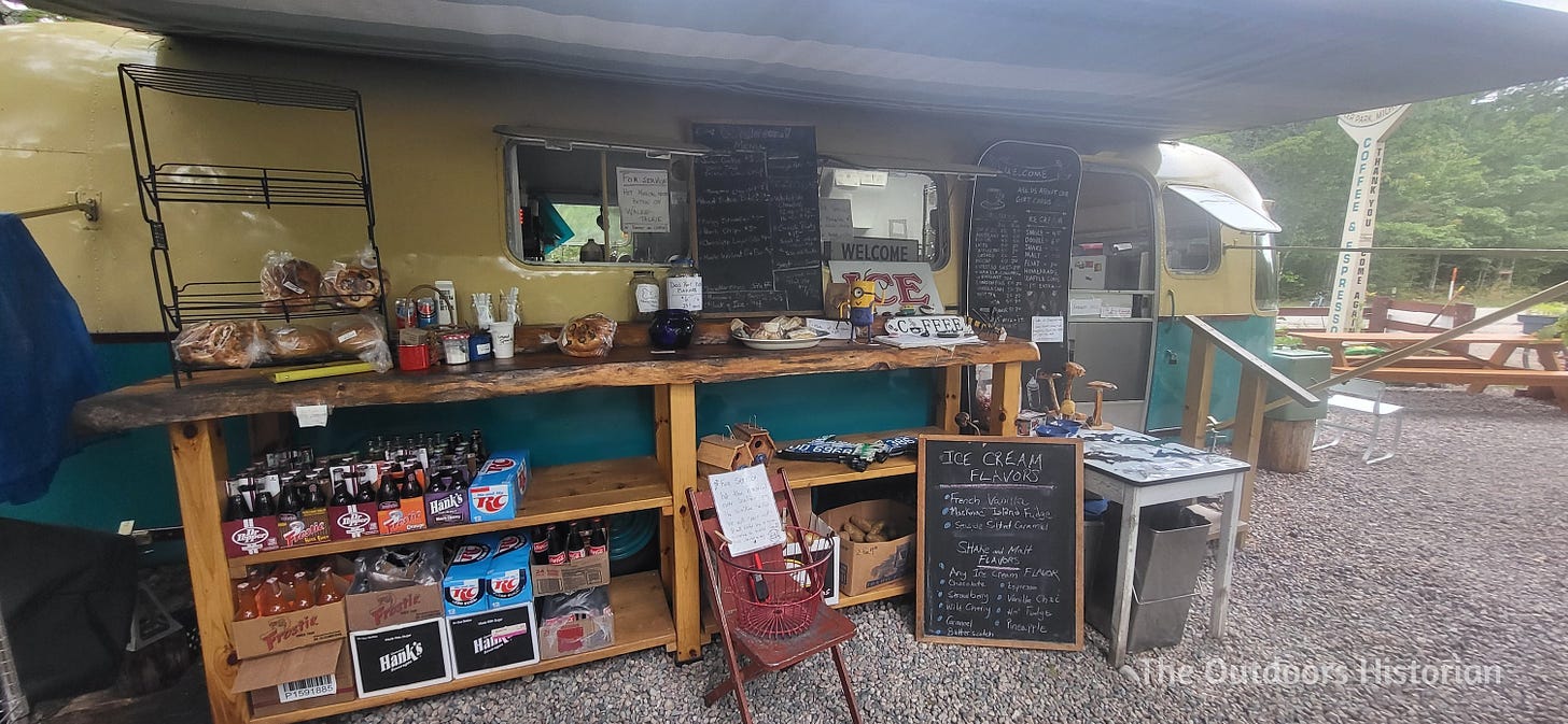 A cute old-school camper trailer that has been converted into a bakery that also sells coffee, ice cream, savory treats, breads, gifts, etc. 