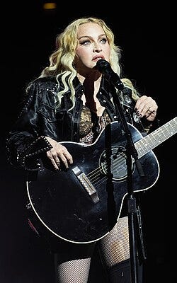 Madonna standing behind a microphone Madonna standing behind a microphone