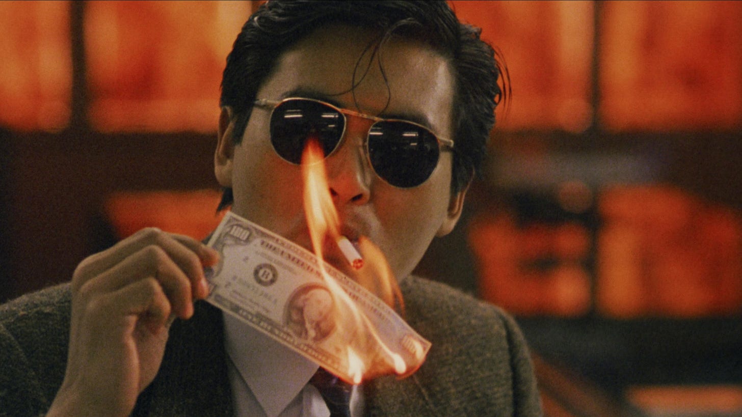 A Better Tomorrow | Still features Chow Yun-fat as Mark Lee lighting a cigarette with a dollar bill on fire.