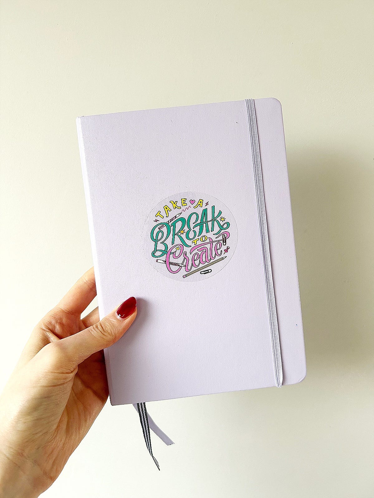 lilac craft planner notebook decorated with a sticker that reads take a break to create
