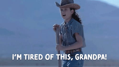 Screencap of child-aged Louise Walker from Holes leaning on a shovel. The image is captioned "I'm tired of this, grandpa!"