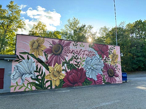 Blue heron statue, pumpkins on wagon, MD Garage at night, trail leading toward tunnel, mural in Canal Fulton, deck overlooking wetland