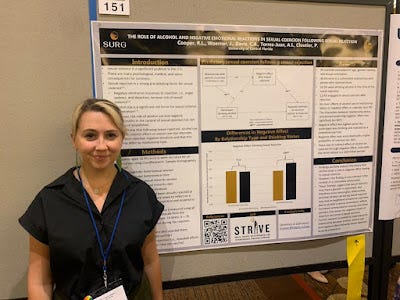 One person standing by a green conference poster with text and graphs.