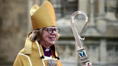 Archbishop of Canterbury Sarah Mullally smiles as she departs following her installation ceremony at Canterbury Cathedral, south-east England on March 25, 2026. The Church of England became Britain's state establishment church following King Henry VIII's split from the Roman Catholic Church in the 1530s. The British monarch is its supreme governor, while the Archbishop of Canterbury is seen as the spiritual leader of Anglicans worldwide. (Photo by Henry NICHOLLS / AFP) (AFP)