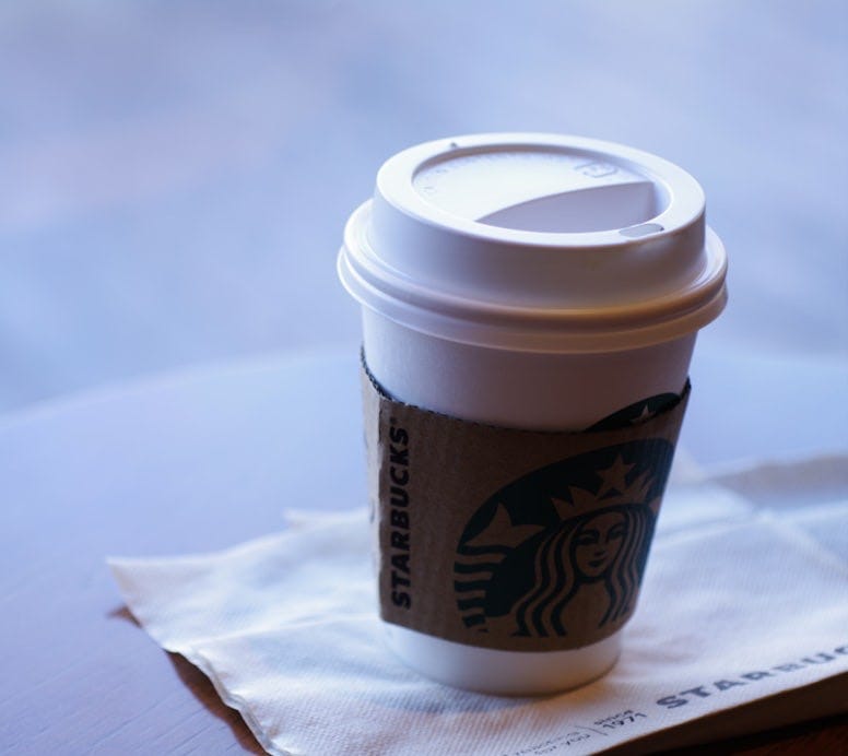 white and brown disposable cup on white tissue paper