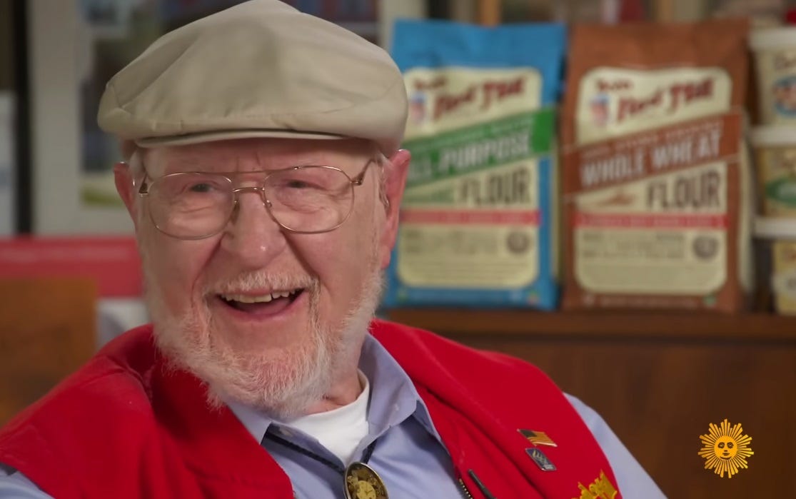 Bob Moore at 91, in signature flat cap, red vest, and bolo tie. Bob Moore at 91, in signature flat cap, red vest, and bolo tie.