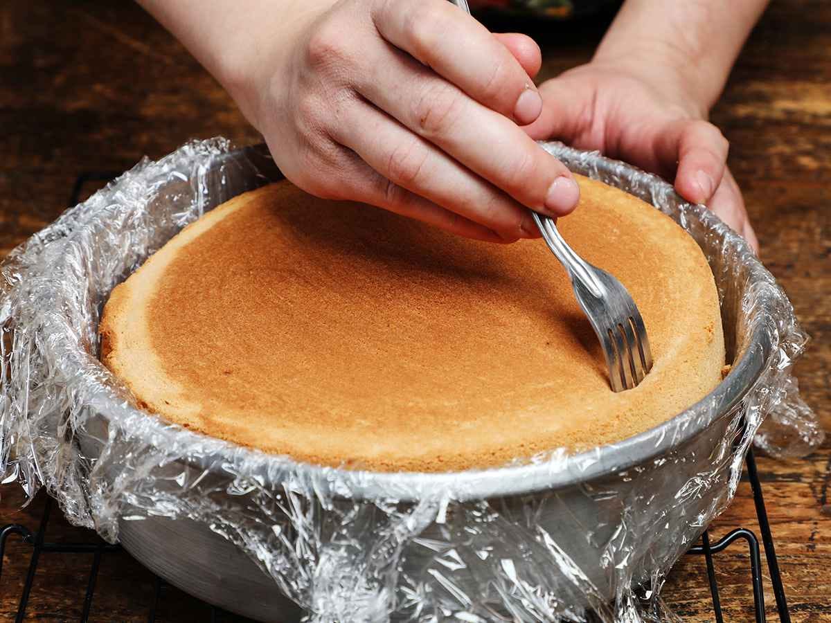 Poking holes into cake with fork