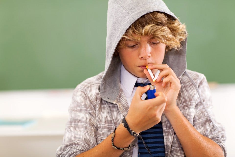 bad high school teen boy lighting cigarette in classroom  Copyright: Getty Images - Getty