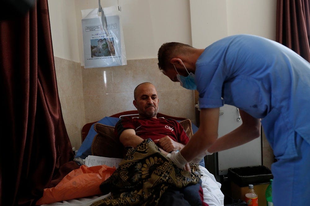 In this Tuesday, June 16, 2020 photo. Palestinian nurse checks a cancer patient Jehad al-Qedra, 52, while he received his treatment at a hospital in Khan Younis refugee camp, Gaza Strip In this Tuesday, June 16, 2020 photo. Palestinian nurse checks a cancer patient Jehad al-Qedra, 52, while he received his treatment at a hospital in Khan Younis refugee camp, Gaza Strip