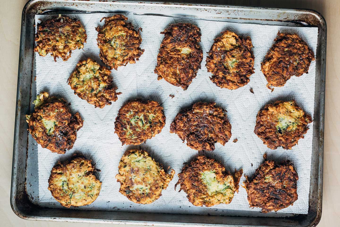 A baking sheet with fried fritters. 