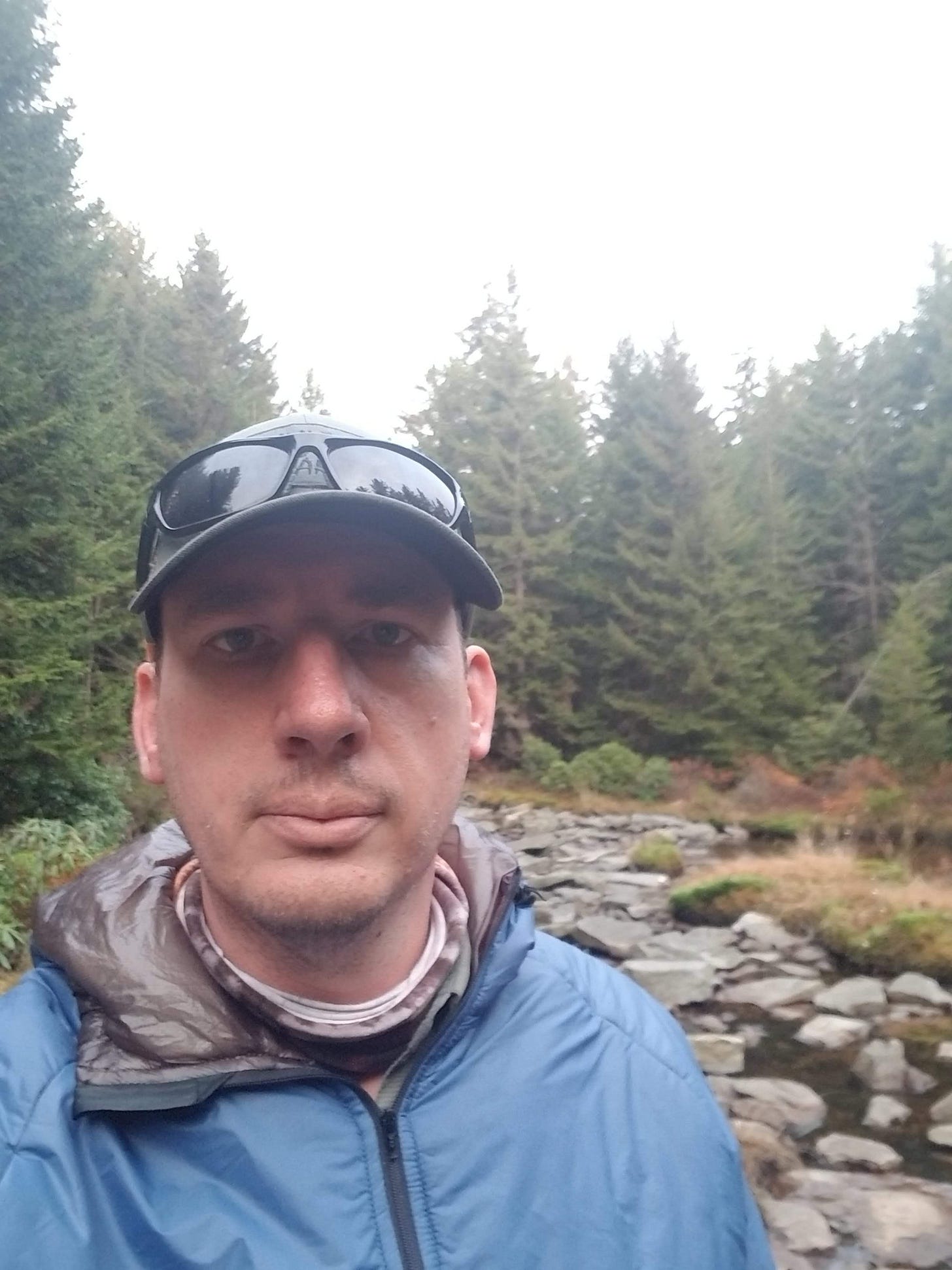 Matthew Long standing outdoors in a wooded area. Matthew Long standing outdoors in a wooded area.