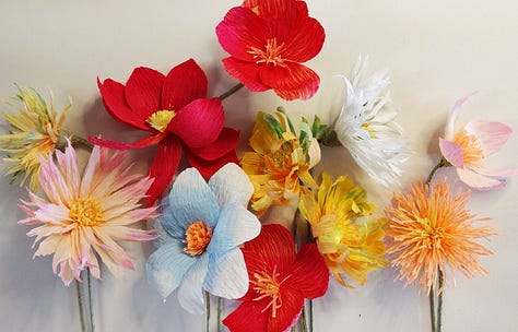 A range of different paper flowers from brightly coloured fantasy flowers to detailed wildflowers