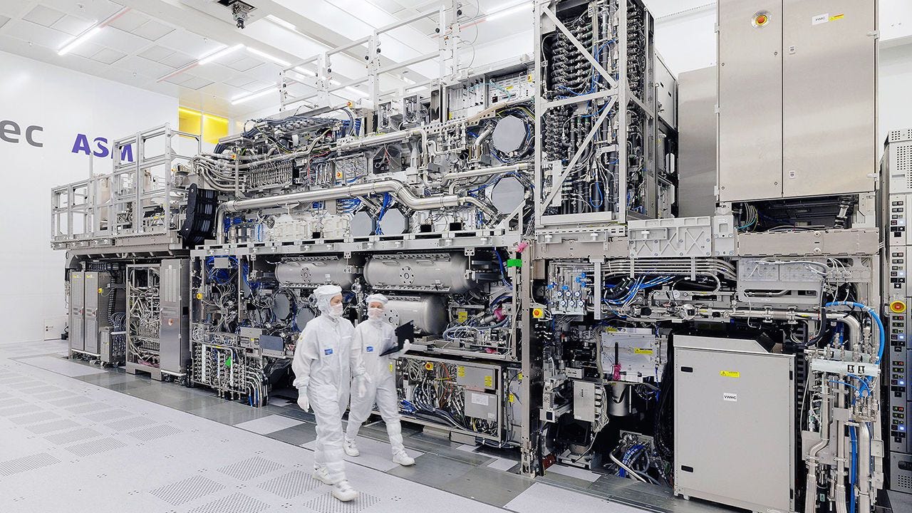 Two people dressed in white overall suits in the Cleanroom at ASML Headquarters in Veldhoven, Netherlands. Two people dressed in white overall suits in the Cleanroom at ASML Headquarters in Veldhoven, Netherlands.