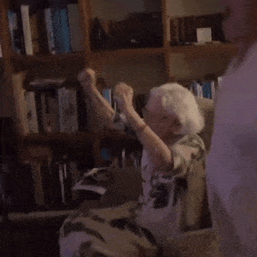 a man and an older woman are playing a video game
