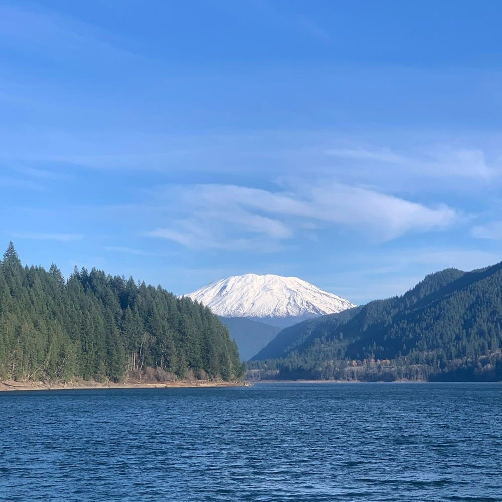 a large body of water with a mountain in the background a large body of water with a mountain in the background