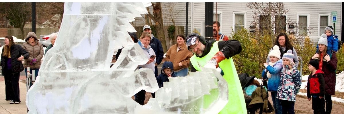 Ice sculptor creating a dinosaur at a winter downtown festival meant to bring foot traffic to the downtown corridor. Ice sculptor creating a dinosaur at a winter downtown festival meant to bring foot traffic to the downtown corridor.