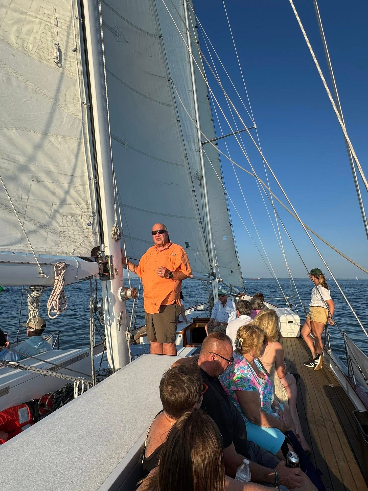 May be an image of 5 people, people boat racing, sailboat and sail